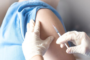 A professional physician administers an injection into the arm of a patient in a facility in Fort Worth, TX.