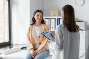 Female patient at an annual wellness exam with her doctor at an office in Farmer's Branch, TX.