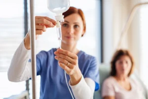 Nurse in Farmer's Branch, TX getting IV infusion ready for a patient.