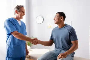 Simply Direct Medicine—A doctor shakes hands with a male patient in his medical office in Farmers Branch, TX.