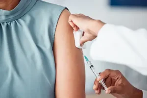Simply Direct Medicine—A doctor administers an injection to a female patient’s arm in her office in Farmers Branch, TX.