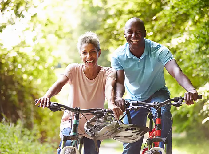 man and woman on a bike ride after starting their weight loss journey with Simply Direct Medicine in Dallas TX
