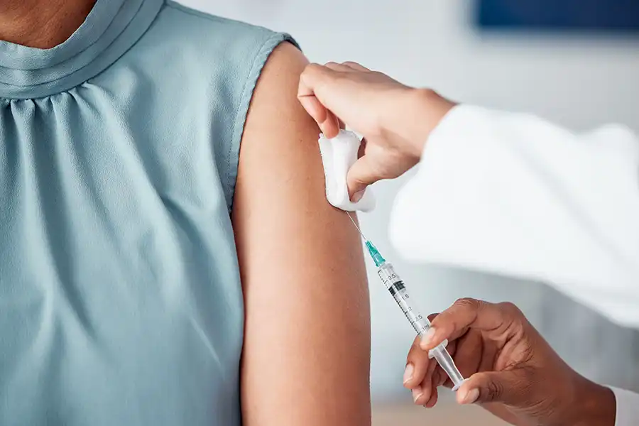 Simply Direct Medicine—A doctor administers an injection to a female patient’s arm in her office in Farmers Branch, TX.