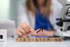Simply Direct Medicine—A female doctor sits at a desk with wooden blocks that spell out “testosterone” in an office in Farmers Branch, TX.